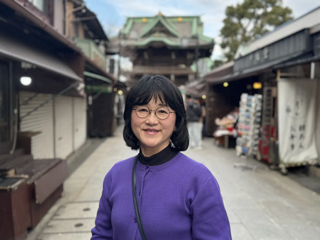 Yumi, licensed tour guide in Tokyo, smiling outdoors